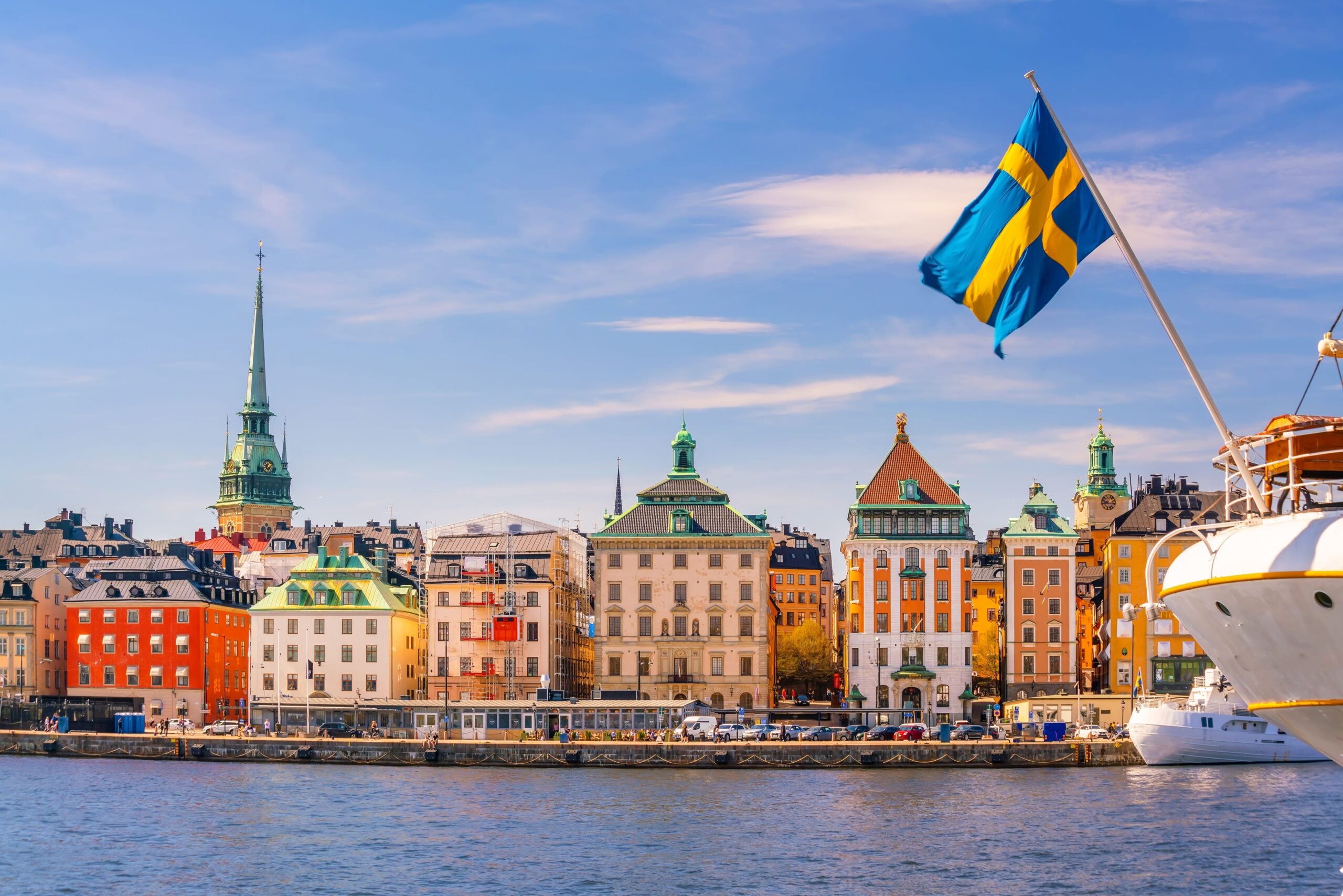 A view of the river in Stockholm: a boat with the Swedish flag.